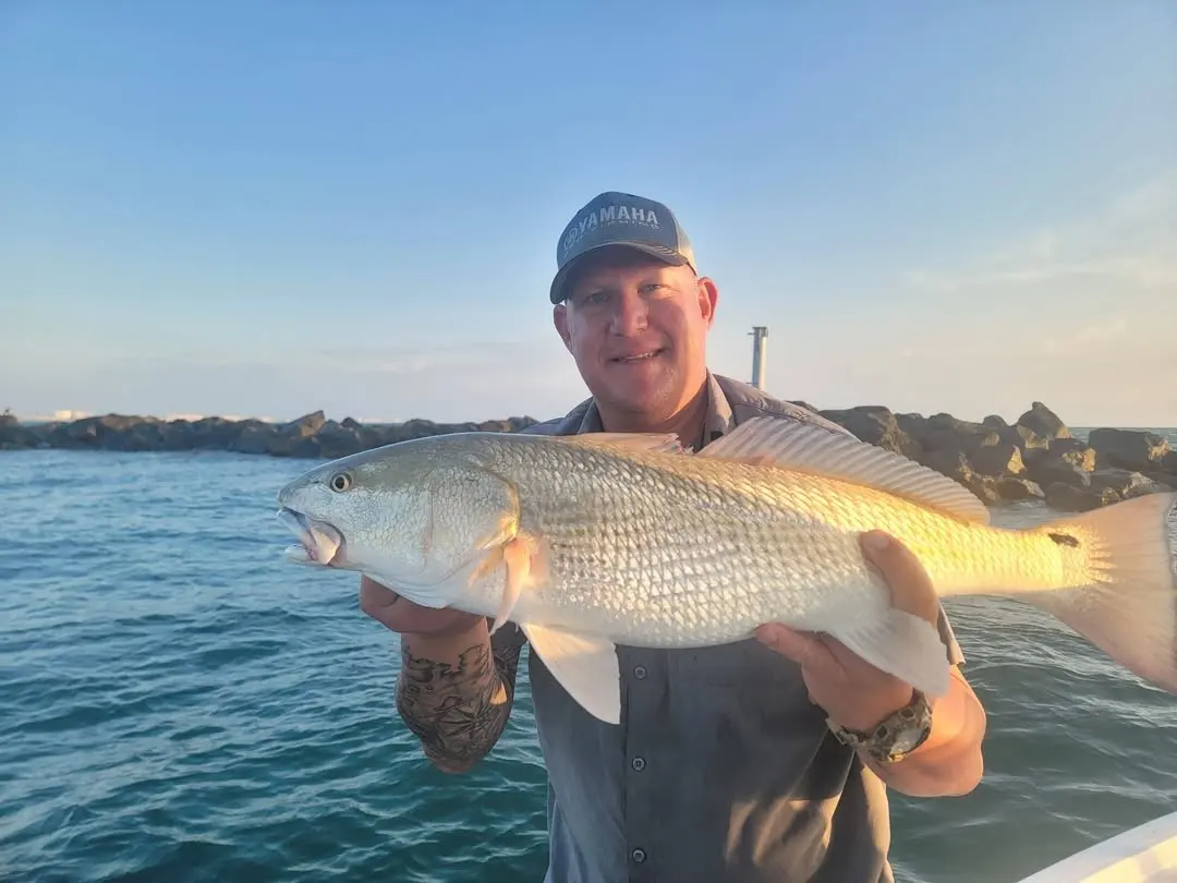 Angler with a redfish at sunrise