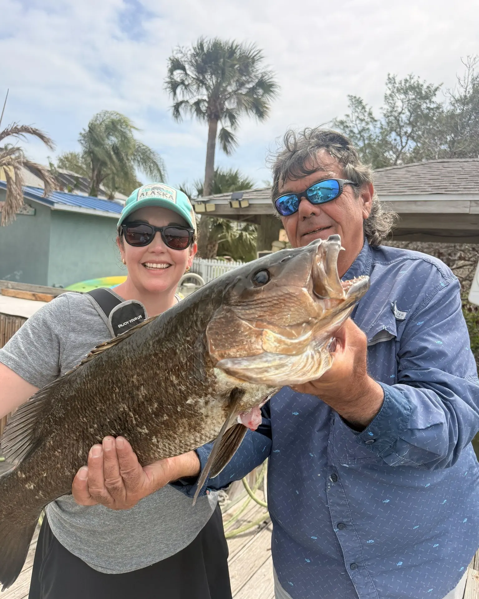 Guest and Captain Fred with a grouper