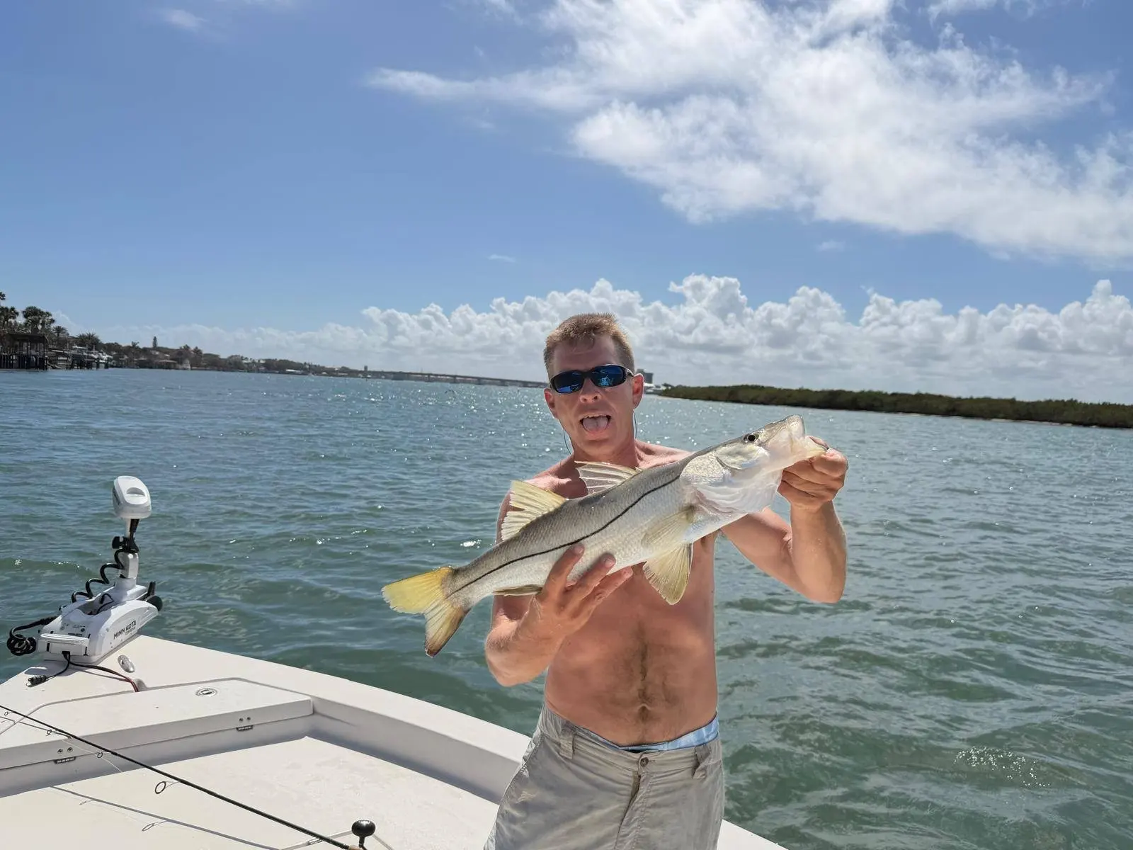 Angler with a snook on a summer morning