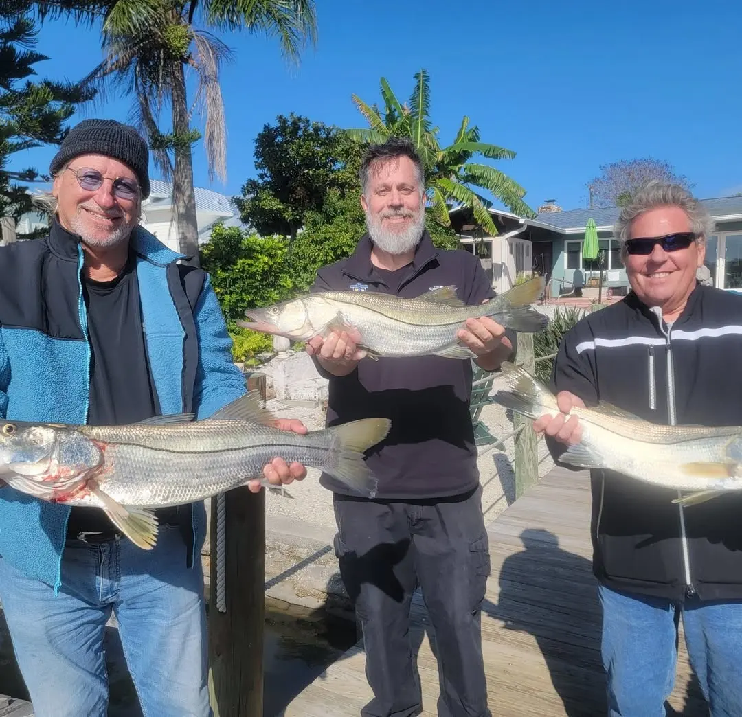 Three anglers with redfish