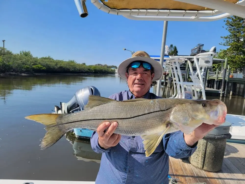 Captain Fred with a snook at the dock