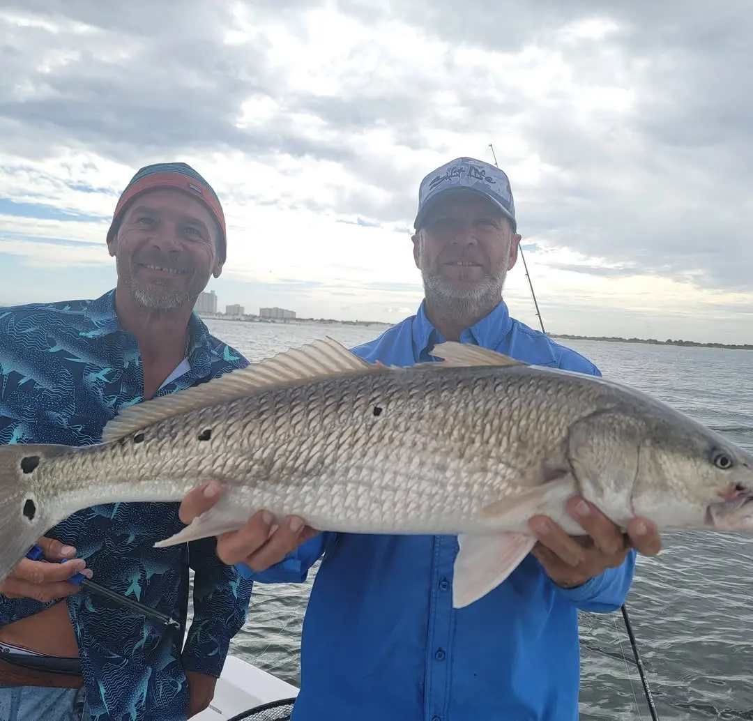 Two anglers with a redfish