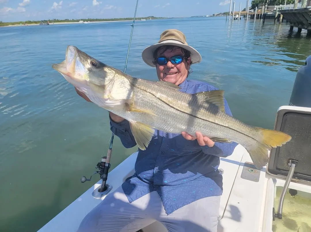 Angler with a snook on the flats