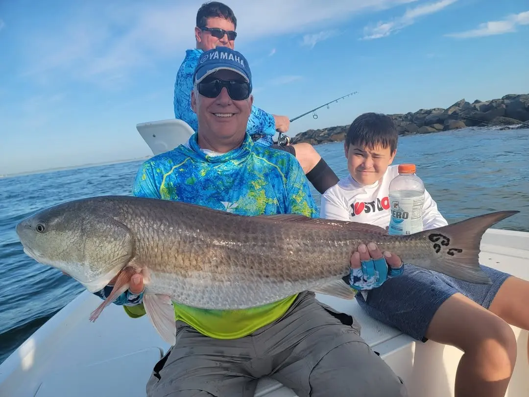 Father and son with a redfish