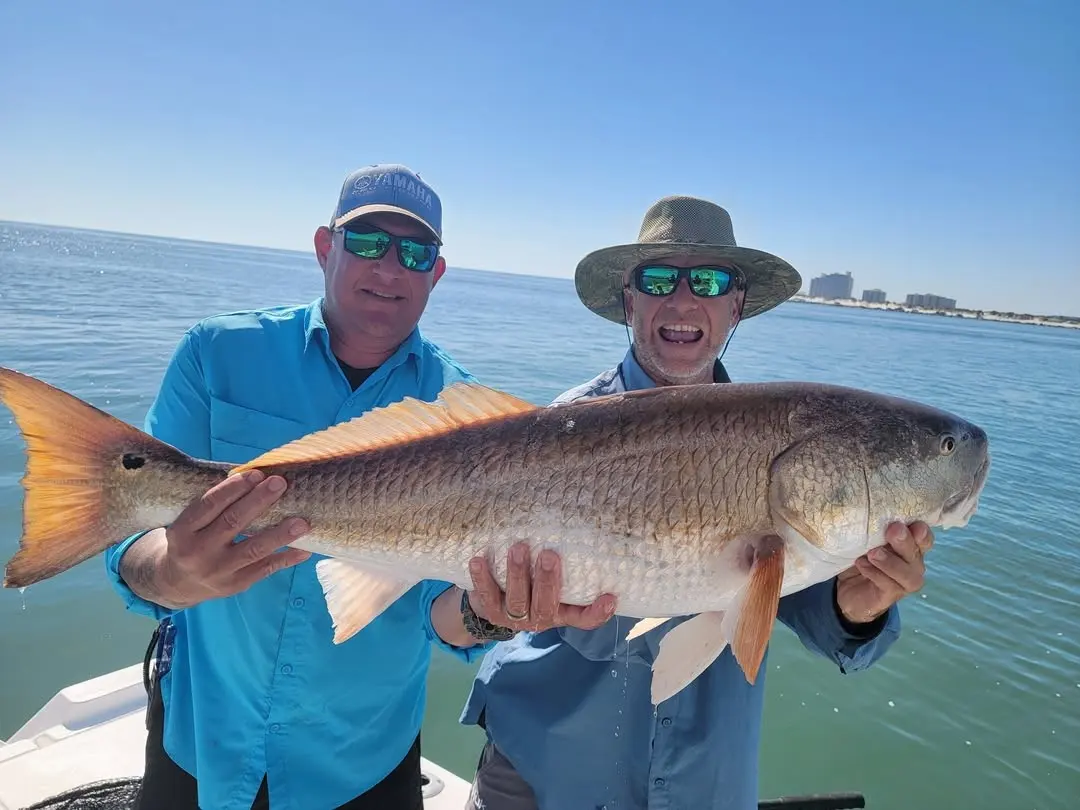 Two anglers with a redfish