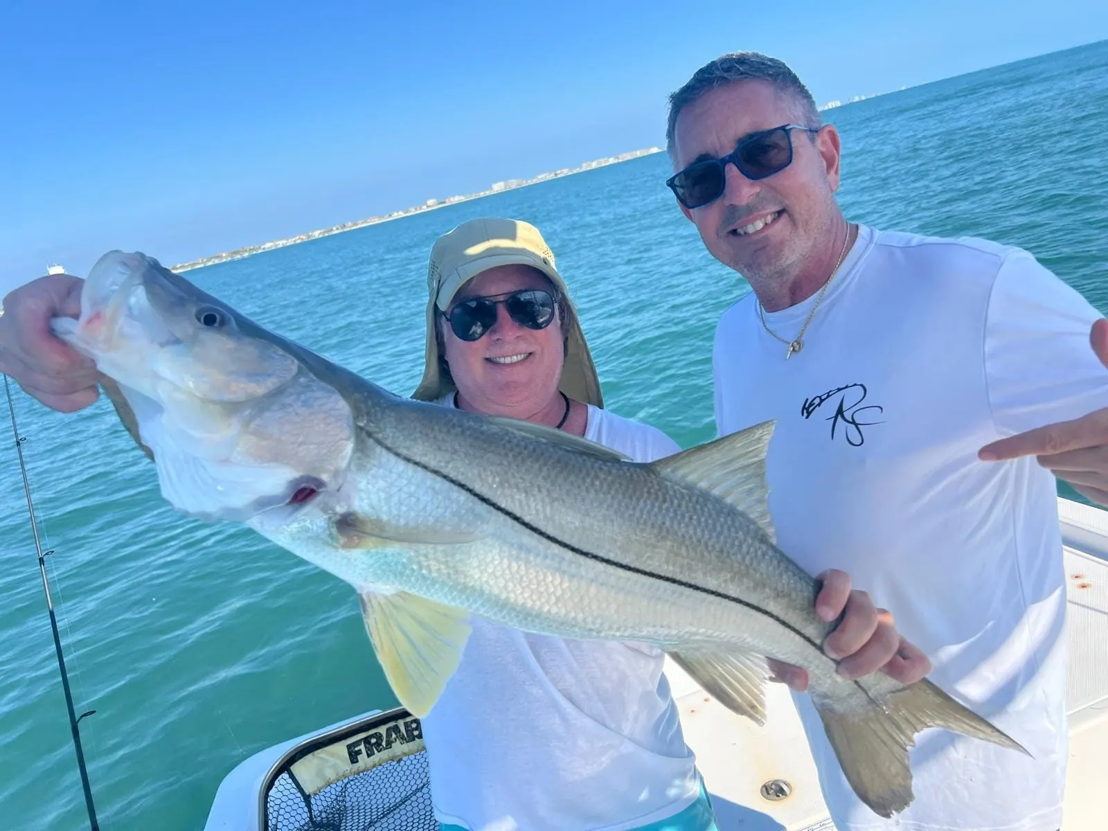 A guest holding up a redfish with a big smile